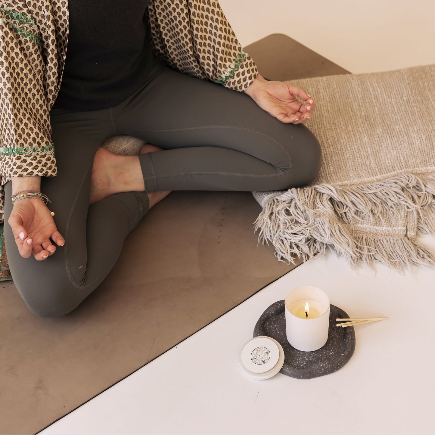 Shō-moon Meditation Candle with QR code and someone meditating with a candle