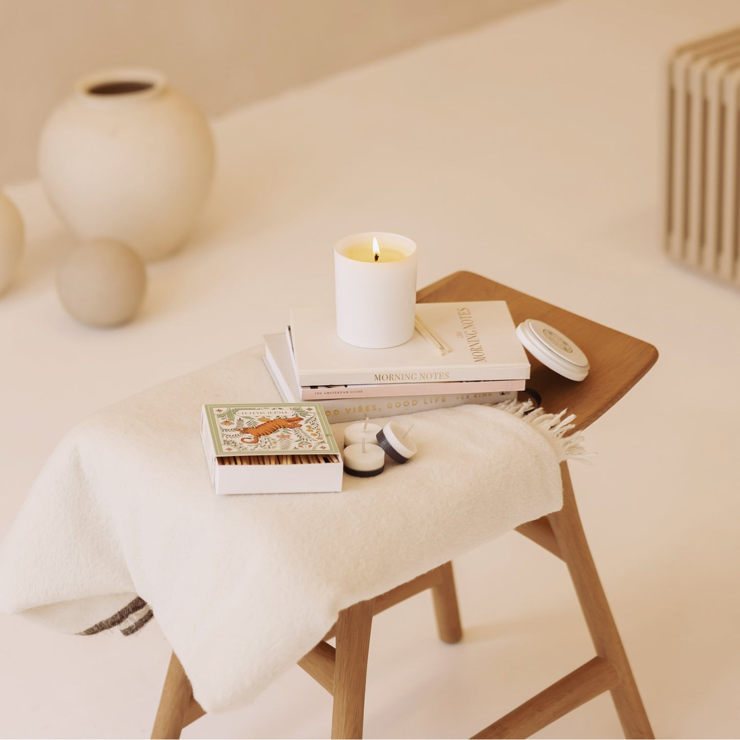 Shō-moon Energise Meditation Candle Resting on Books and Journal in a beige aesthetic
