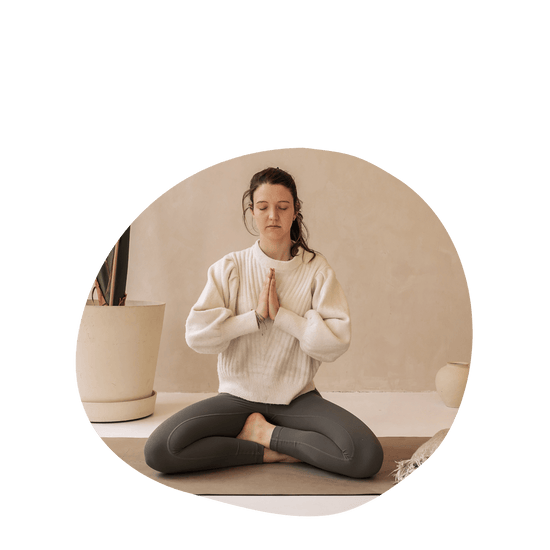 Woman meditating on a yoga matt crossed legs