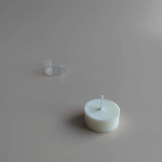 Shō-moon natural Tealights candle refill going in and out of tealight holder